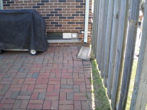 Drainage error causing erosion of pavers