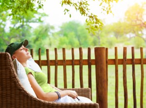 Cute girl resting on veranda, young traveler woman sleeping on b