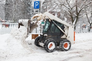 Small Excavator Bobcat Working On The Street