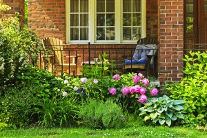 Front of home with chairs and flower garden