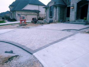 in progress photos of a paver driveway project in ann arbor