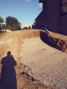 in progress photos of a paver project. seen a large hole in the ground