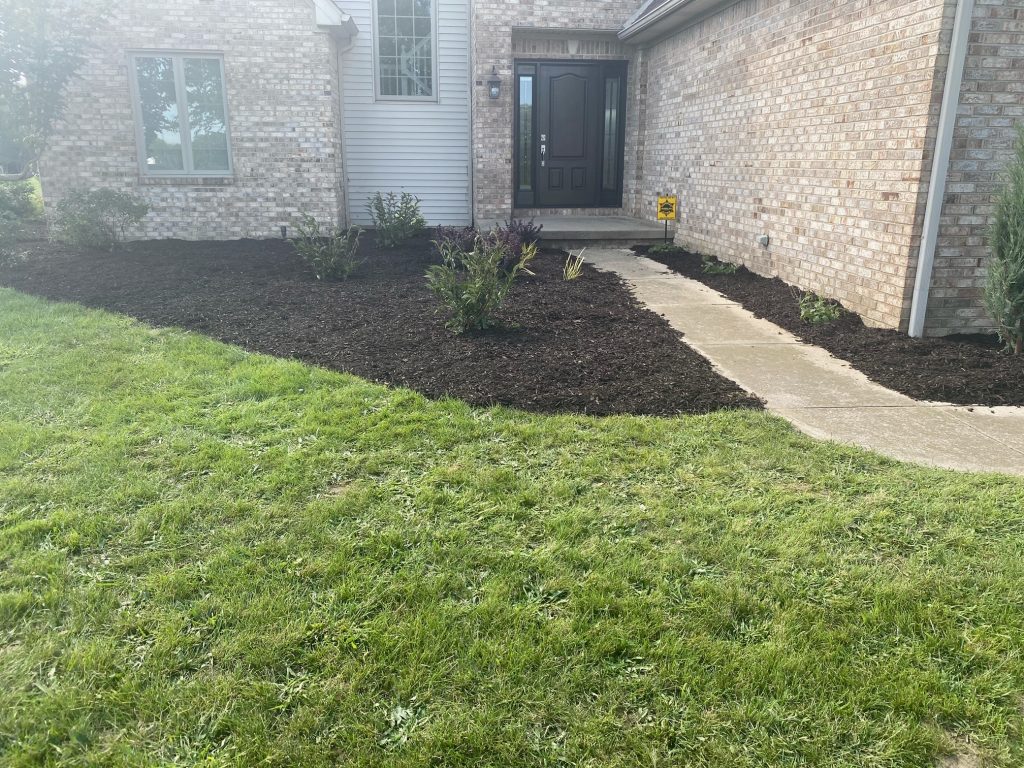 mulched in areas by the front door of a home