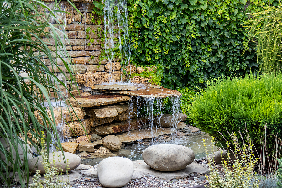 A small decorative water fall in a garden. 