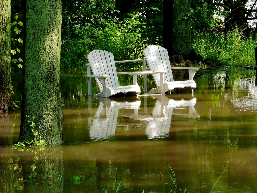 Submerged lawn chairs sunshine after the rain.