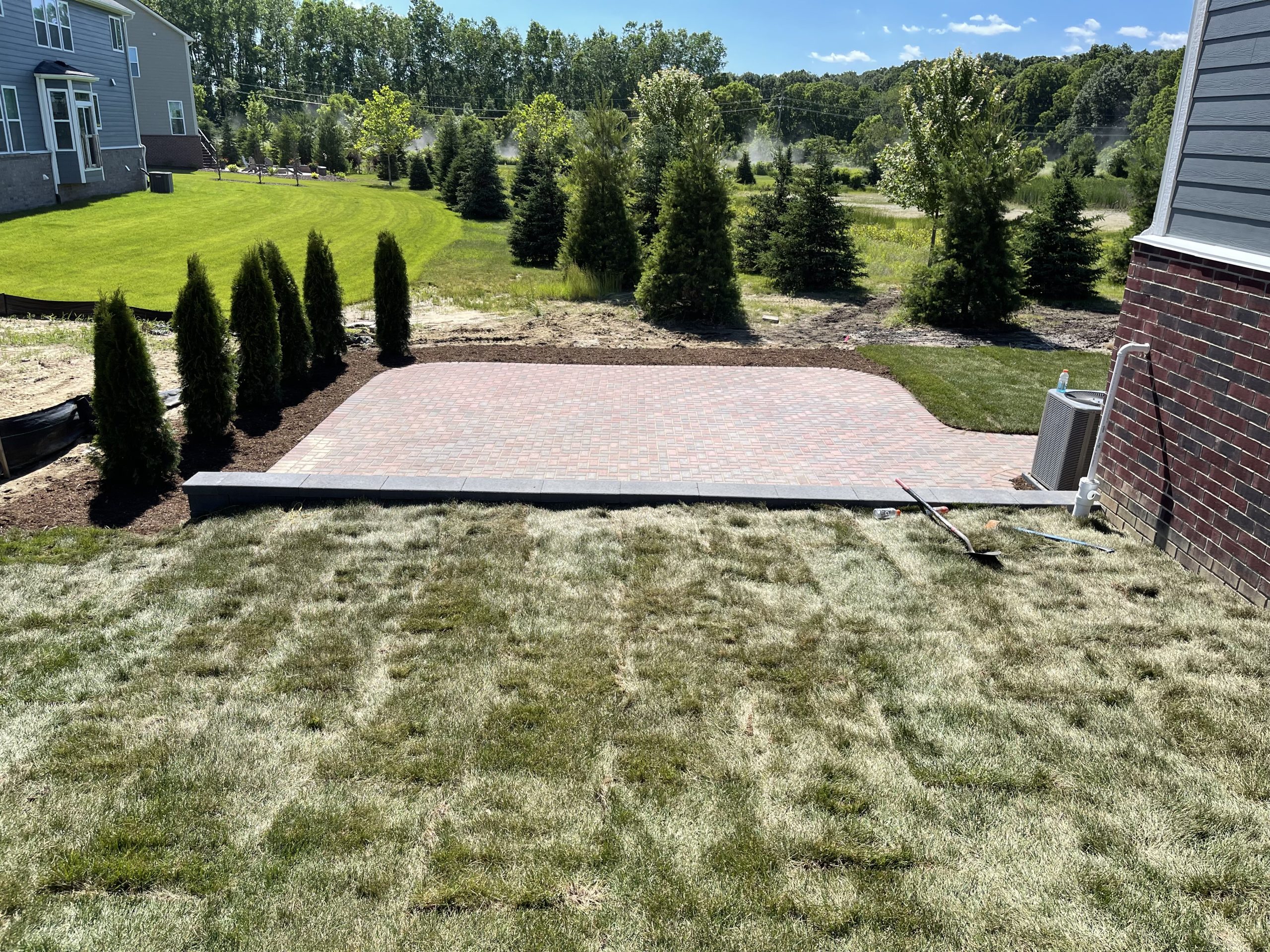 Paver patio, sod, and retaining/sitting wall finished.