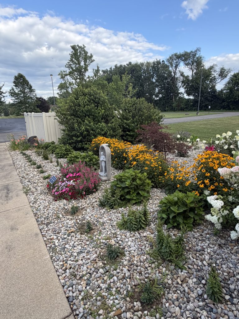 Stone Covered Flowerbed along front sidewalk