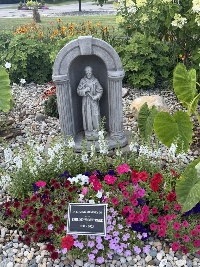Catholic Shrine with landscape project flowers and placard