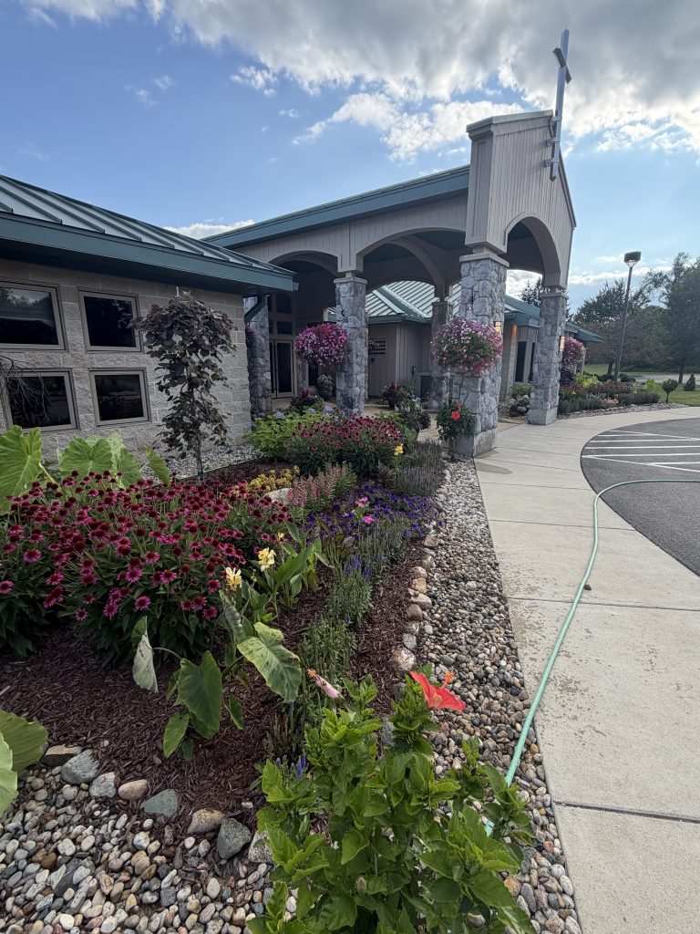 Landscape project flowerbeds in front of commercial building driveway